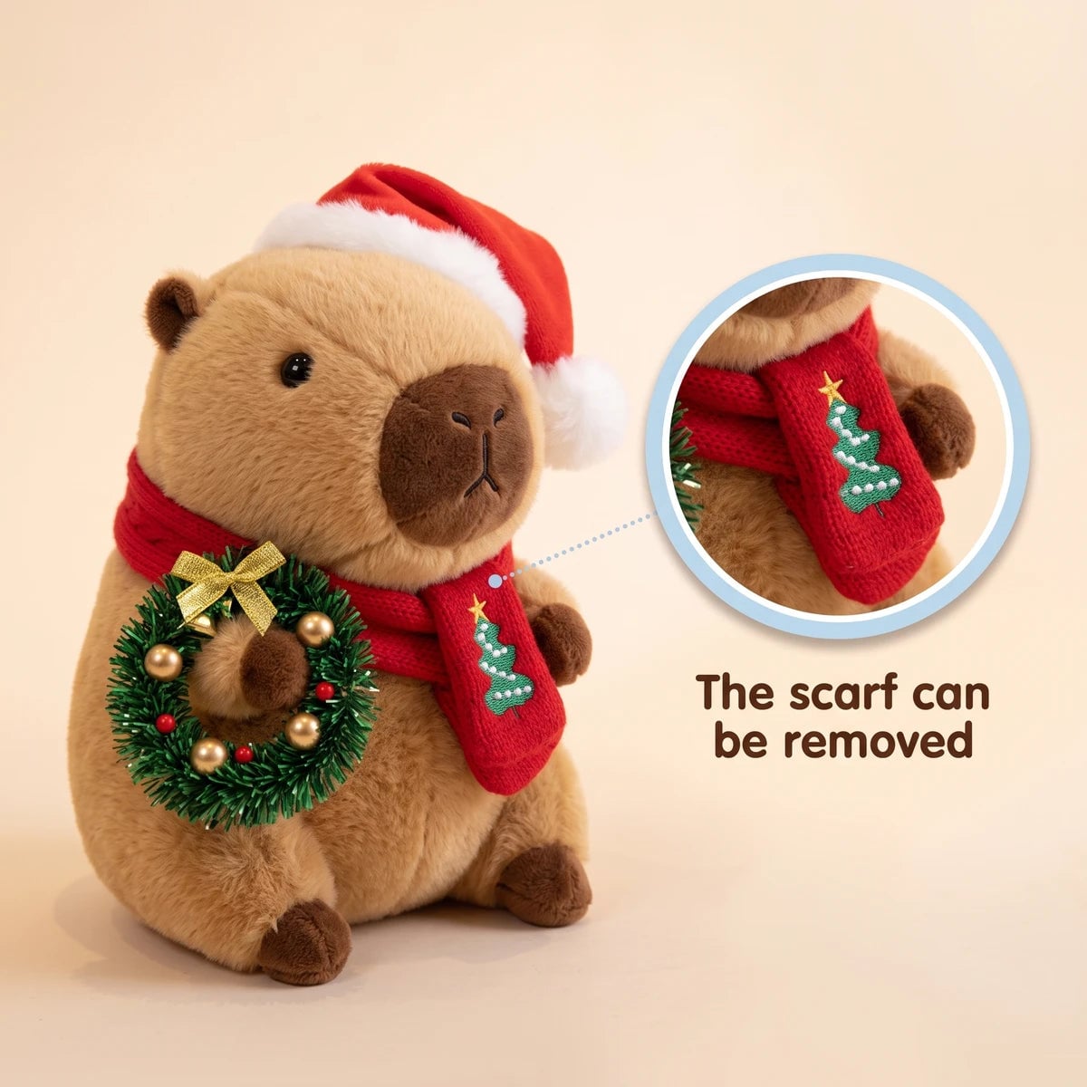 Christmas capybara plush with a Santa hat holding a green wreath with a close-up showing that the scarf can be removed