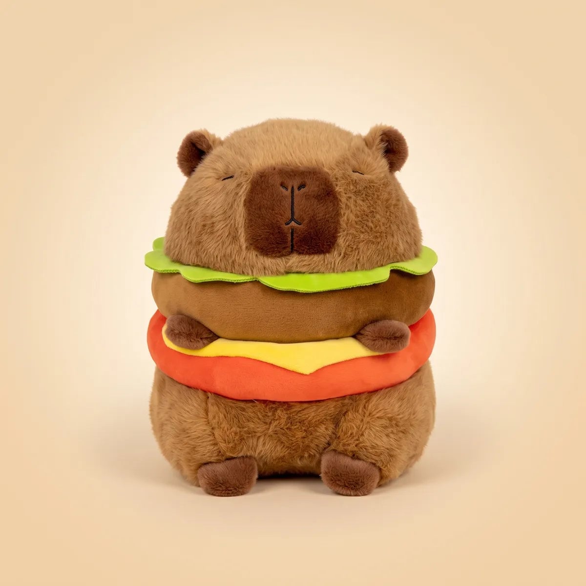 Capybara burger plush seen from the front with its lettuce cheese and tomato layers