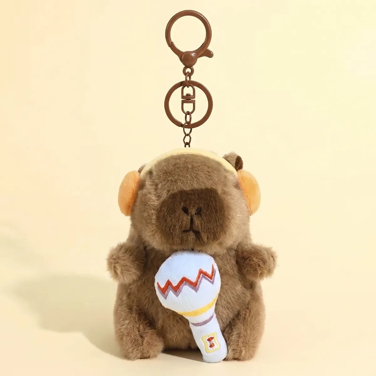 Microphone capybara keychain hanging from its metal lobster clasp
