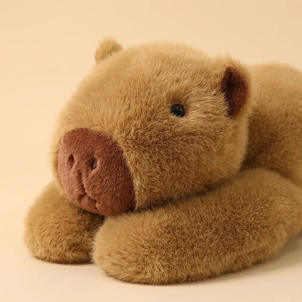 Close up of the rosy stitched snout of the weighted capybara plush