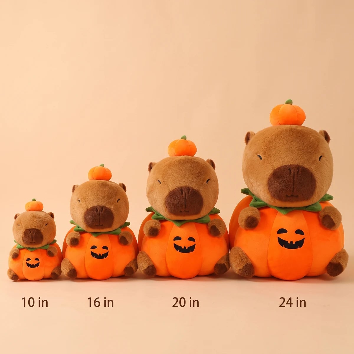 Pumpkin capybara plush in four sizes side by side, 10 in, 16 in, 20 in and 24 in