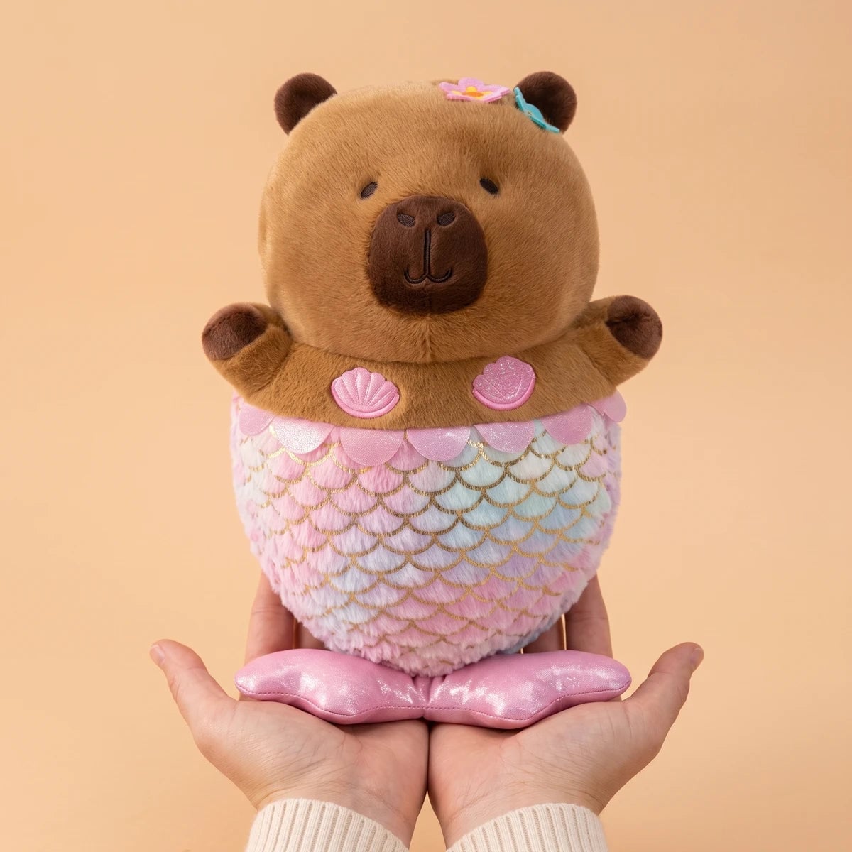Mermaid capybara plush standing on two hands to show its 12 in size
