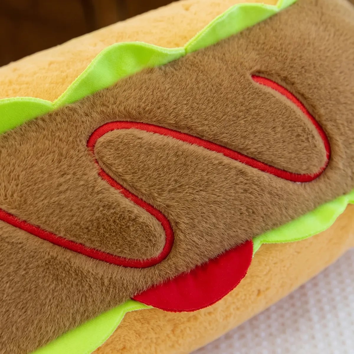 Detail of the red ketchup zigzag on the back of the capybara hot dog plush and the lime green lettuce ruffle edging the bun