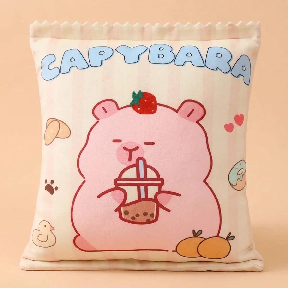 Back of the pink capybara snack bag pillow, printed with a cartoon capybara holding a cup of bubble tea